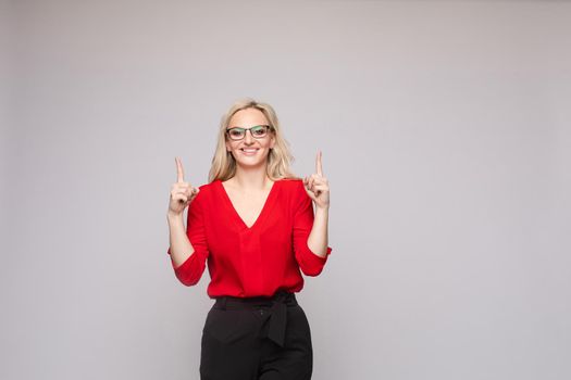 Successful female in smart outfit and glasses posing