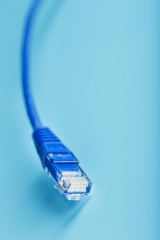Blue Ethernet Cable Cord Patch cord on a blue background with free space