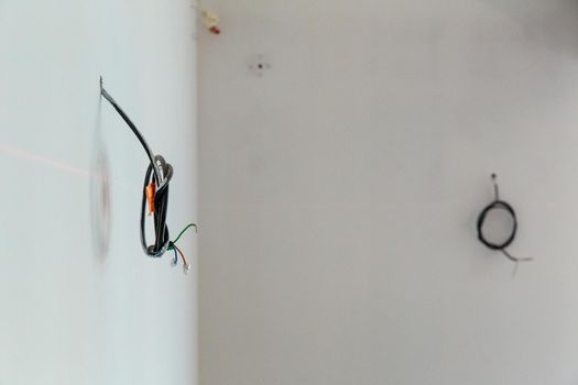 Exposed electrical wires on wall