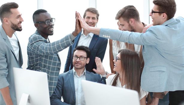 business team members giving each other high five