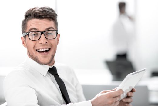 Attractive businessman working with tablet and touching digital display