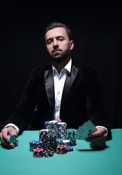 Happy poker player winning and holding a pair of aces