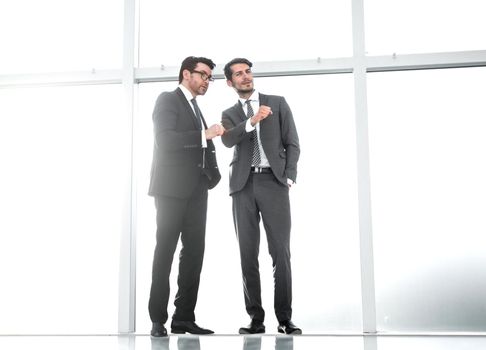 background image.two businessmen point to a copy of the space