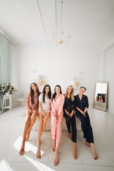 Girlfriends celebrating bachelorette party. Stock photo of five girls in pajamas
