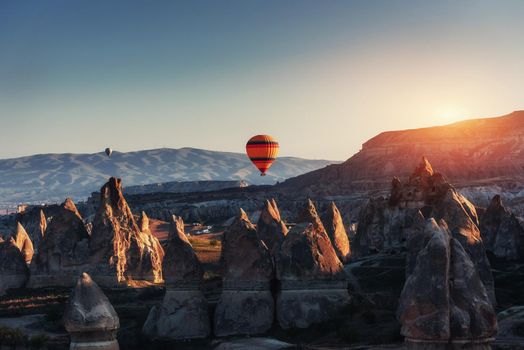 Amazing sunset over Cappadocia. Beautiful color balloons. Turkey