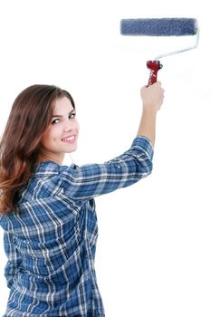 Beautiful woman painting wall with paint roller