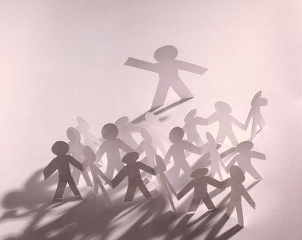 concept of leadership.group of paper men paper background