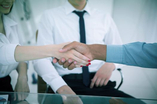 handshake between a business woman and investor
