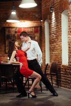 Dancing young couple on a white background. Passionate salsa dan