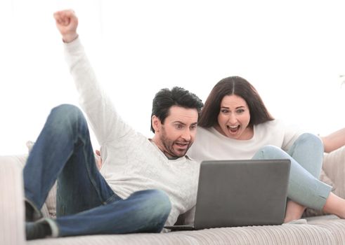 young couple watching TV show on their laptop