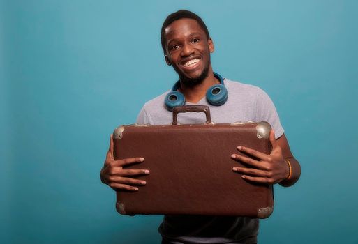 Happy man carrying briefcase luggage to leave on vacation