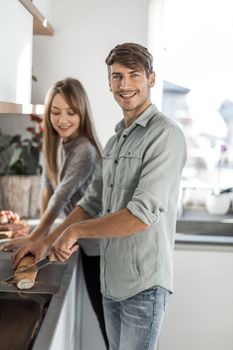 happy young couple enjoying cooking Breakfast together.