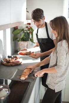 young husband and wife cook Breakfast together