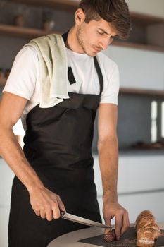 young man preparing a sandwich in the kitchen