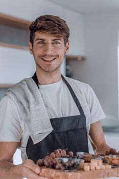 attractive young man showing them cooked Breakfast