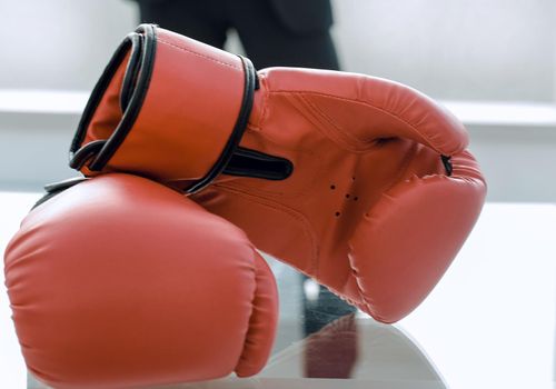 Boxing gloves on the businessman's desktop
