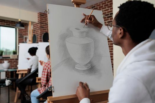 African american student attending art lesson working at creative artwork