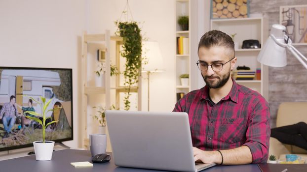 Freelancer taking a sip of coffee while working on laptop