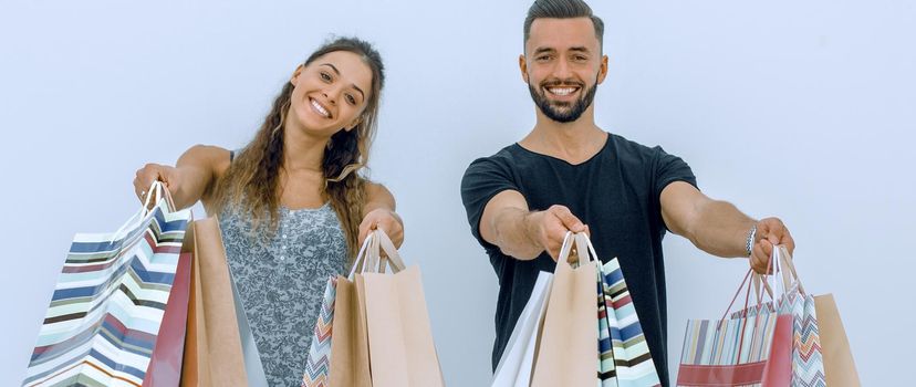 young couple shows shopping bags