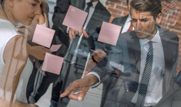 Manager shows business team business notes