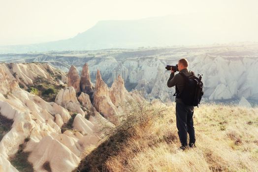 Photographer sandstone cliff and observing the natural landscape