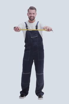 in full growth. smiling man with construction tape measure