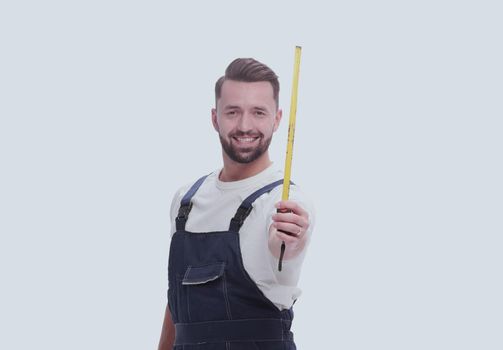 man in overalls with a construction tape measure. isolated on white