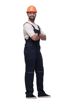 in full growth. smiling man in overalls and a safety helmet