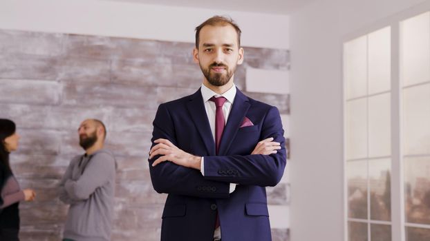 Real estate agent in business suit holding arms crossed