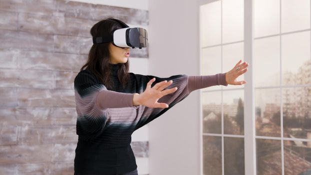 Beautiful female home designer using virtual reality goggles