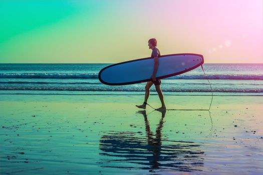 Vacation Silhouette Of A Surfer Carrying His Surf Board Home At Sunset With Copy Space