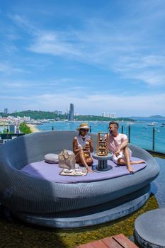 Pattaya Thailand couple men and woman having afternoon tea on a rooftop bar in Pattaya Thailand