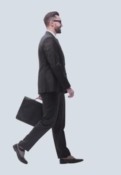 side view . businessman with leather briefcase stepping forward.