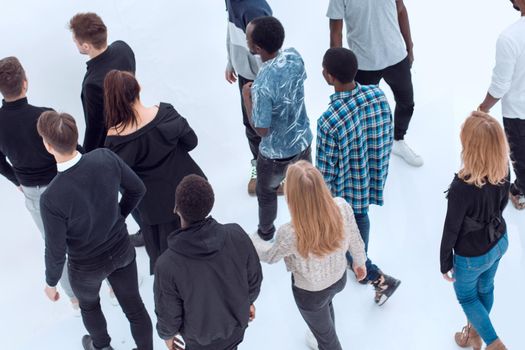 group of diverse young people walking in the same direction