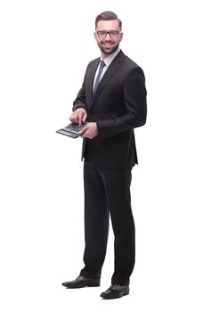 in full growth. Confident businessman counting on calculator