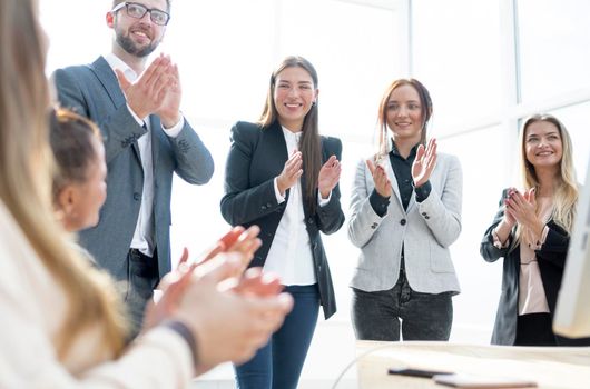 group of young employees applauding their success.