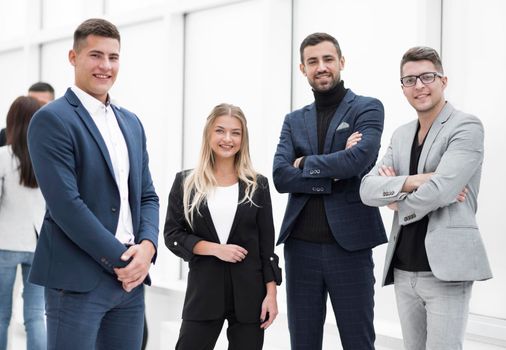 group of ambitious young employees standing in the office.