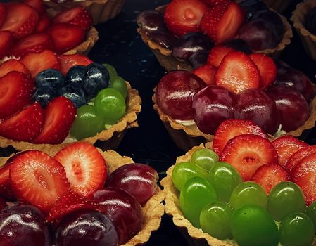 Fruits and berry tartlets and tarts as fruit dessert, sweet food and delicious pastry in bakery