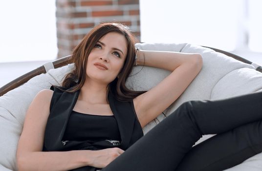 elegant business woman sitting in a comfortable chair.