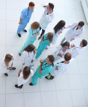 male doctor standing in front of her colleagues.