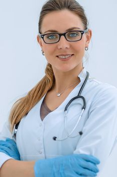 portrait of smiling female doctor on light background