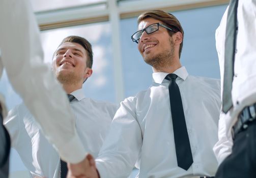close up.happy businessman shaking hands with business partner