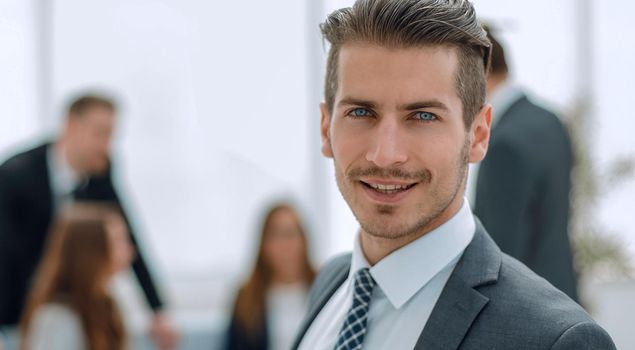 Young man in business suit smiling