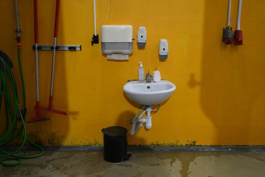 Photo of a bathroom with a washbasin against a yellow wall