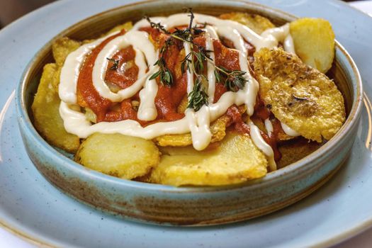 Patatas bravas are a typical preparation of the bars of Spain consisting of potatoes cut into large cubes, fried in olive oil and seasoned with salsa brava, which is a spicy sauce.