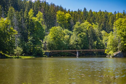 Long steel hanging footbridge over Modre lake