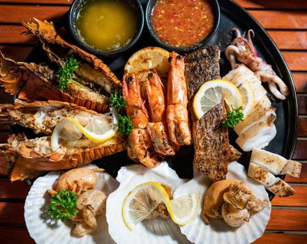 Fresh seafood plate with lobster, Prawns, squid, sea bass and scallop.
