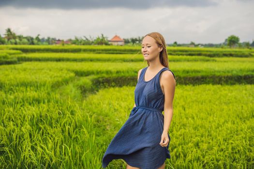 Young woman on Green cascade rice field plantation. Bali, Indonesia
