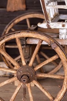 old wooden wheels are on the carriage at the ranch