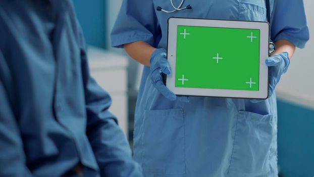 Medical assistant using green screen on digital tablet